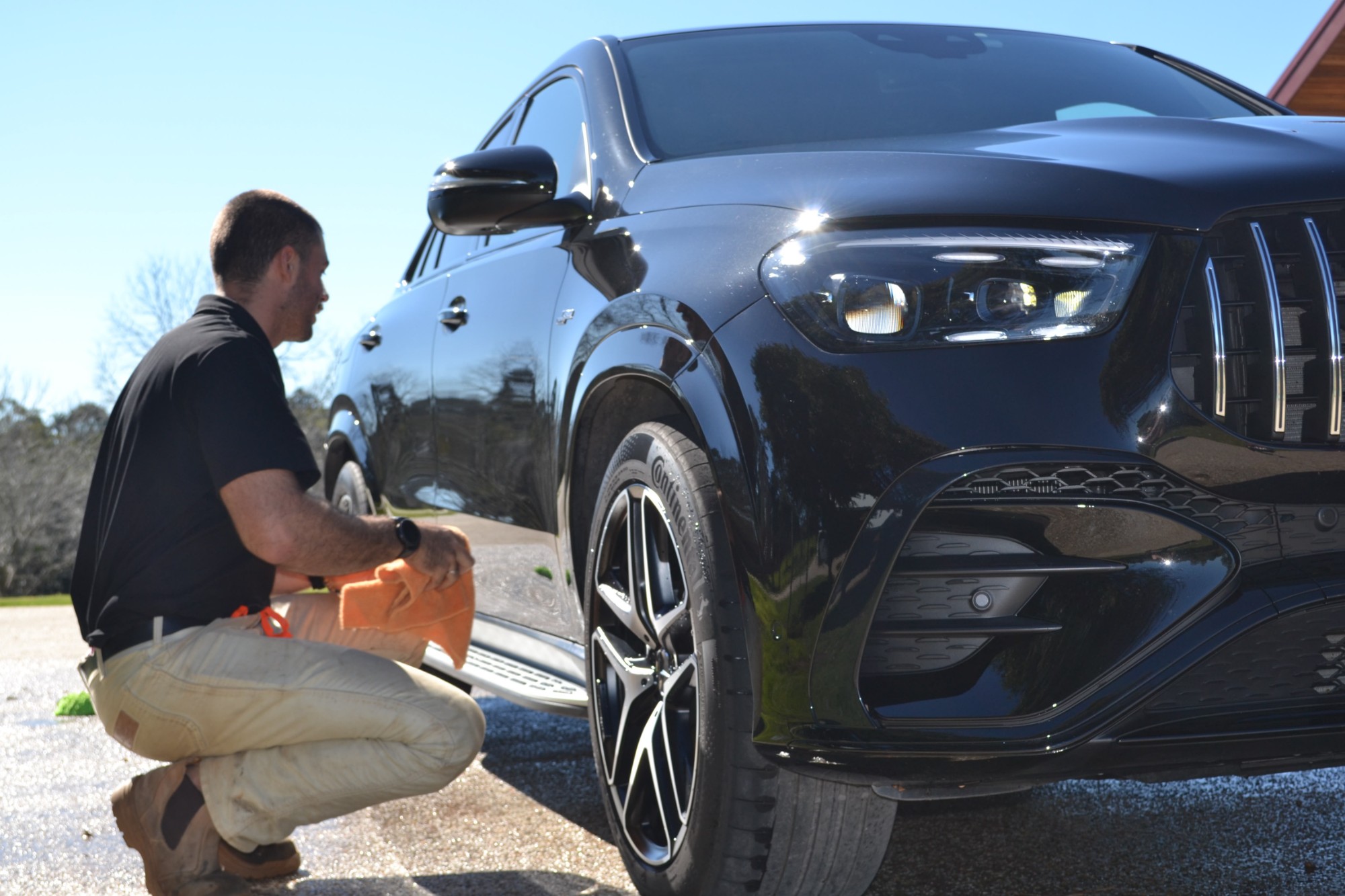 Antoine finishing a Premium Detail on a black Mercedes-AMG