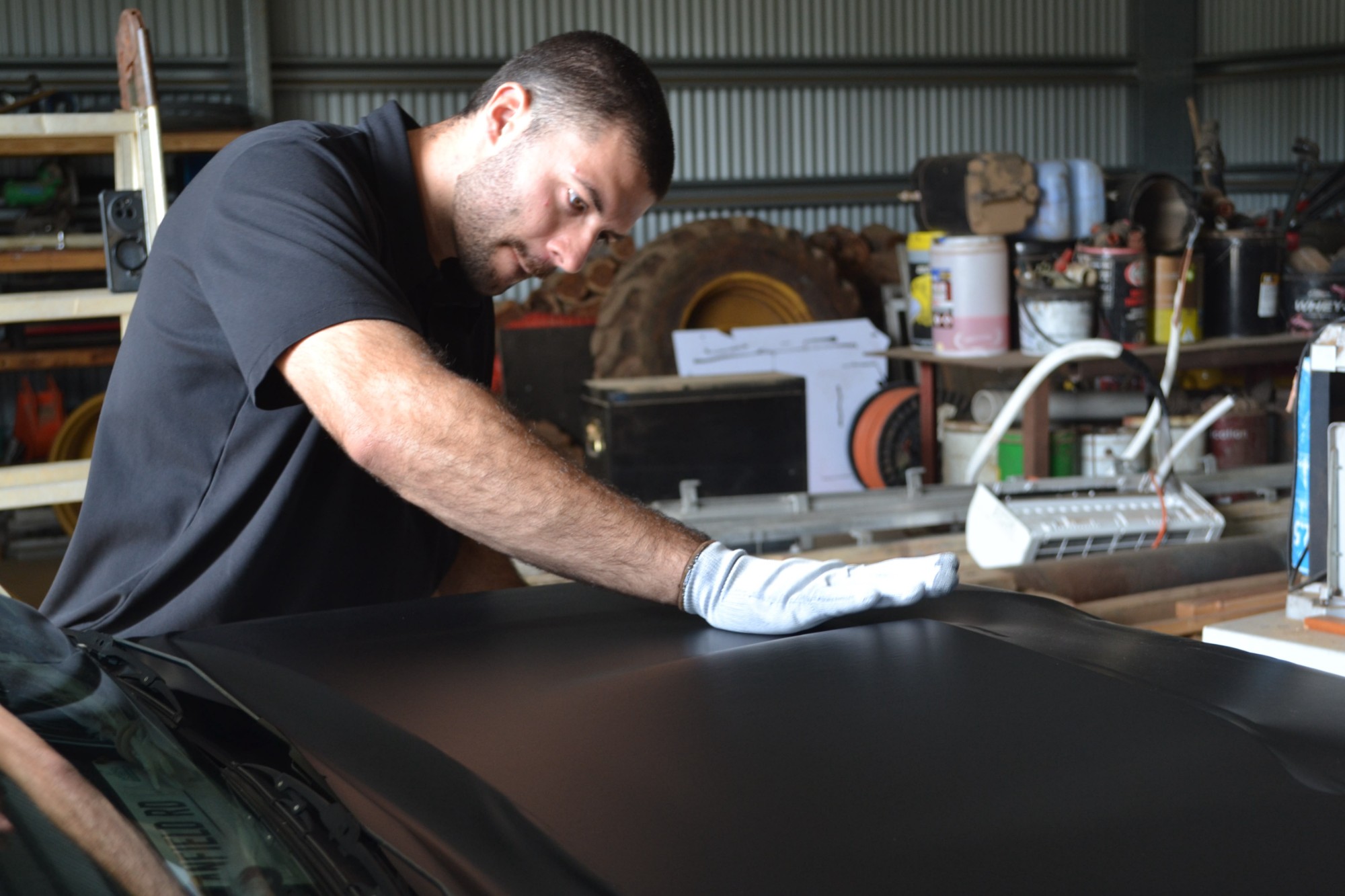 Antoine inspecting paintwork before machine polishing