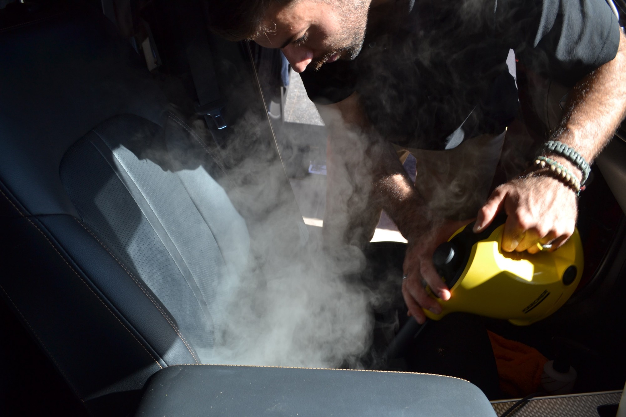 Antoine steam cleaning a leather seat