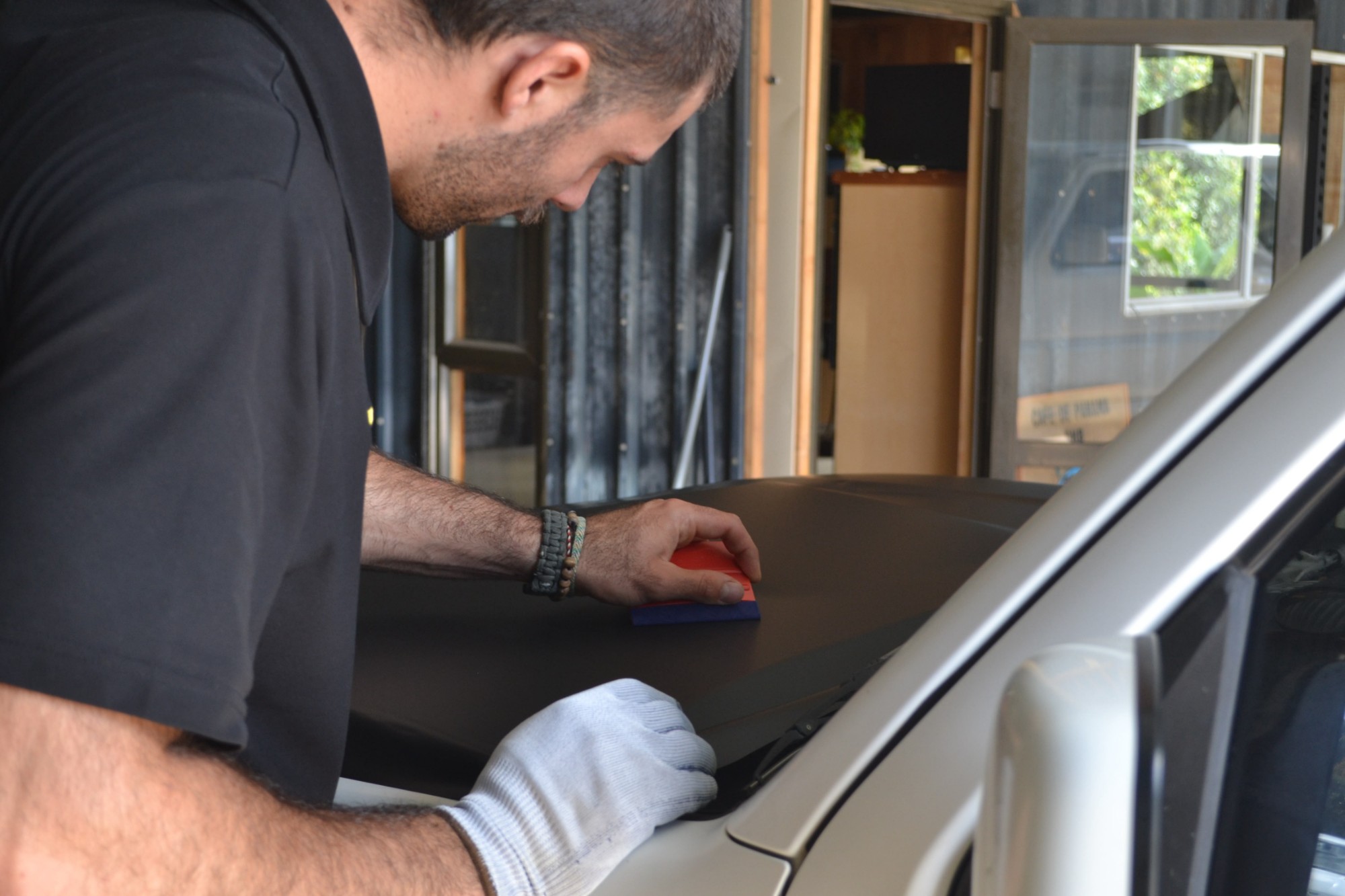 Antoine applying product to a bonnet by hand