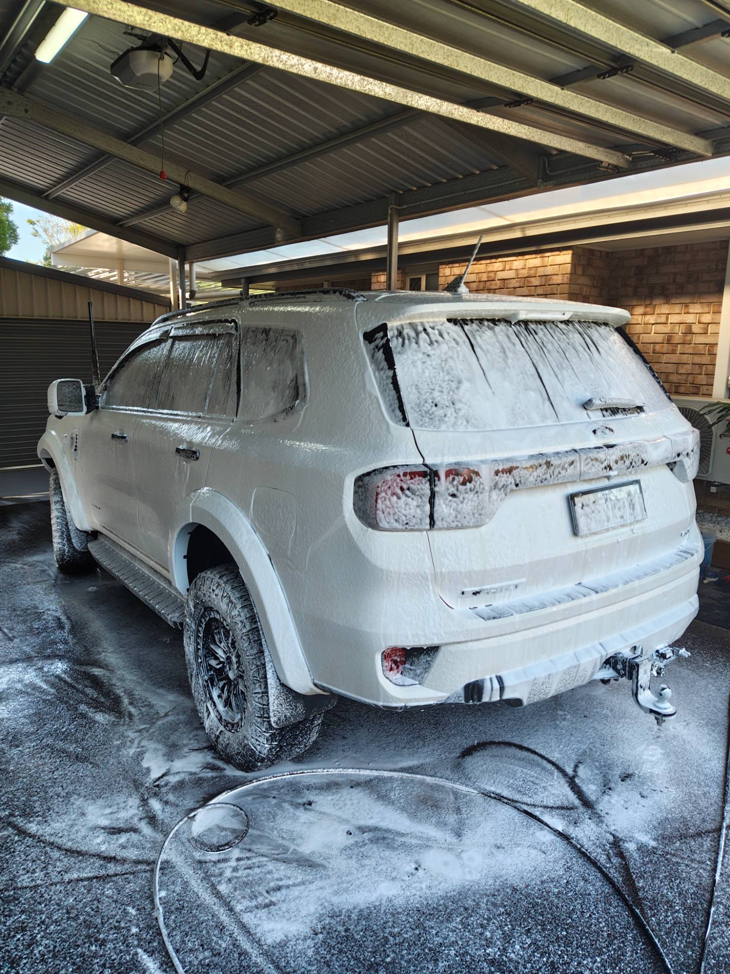 Ford Everest covered in snow foam during a maintenance wash